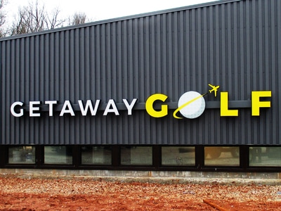 Getaway Golf sign displayed on black billboard