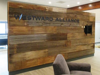 Westward Alliance black lettering on wooden wall